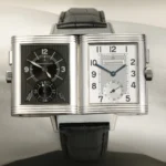 Jaeger-LeCoultre Reverso Duoface avec ses deux cadrans distincts, affichant une complication jour/nuit et une esthétique Art déco emblématique, présentée sur un bracelet en cuir noir.